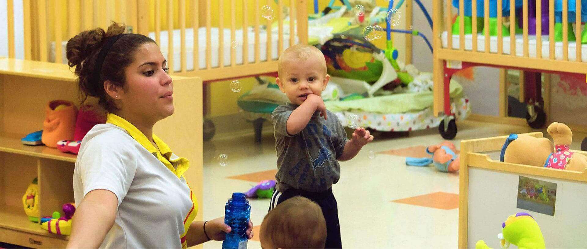 a teacher playing bubbles with kids